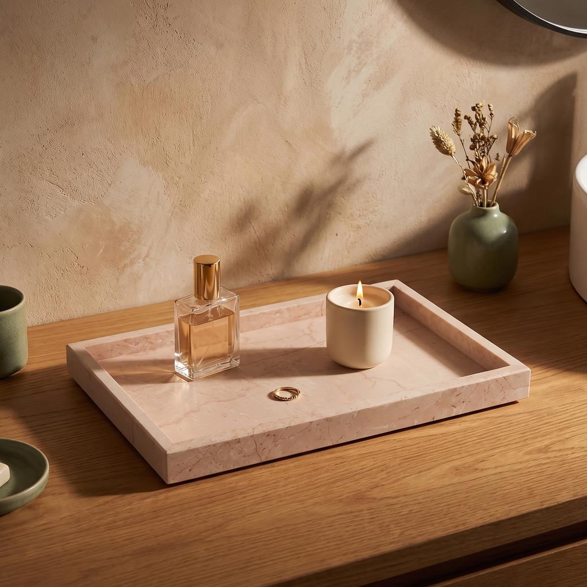 Blush marble tray with perfume and candle on a bathroom vanity