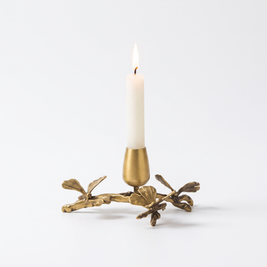 Brass ginkgo taper candle holder for 1 candle on white background