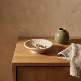 Marble shallow pedestal dish styled on a bathroom vanity counter