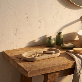 Oval sandstone vanity tray styled on a bathroom washstand