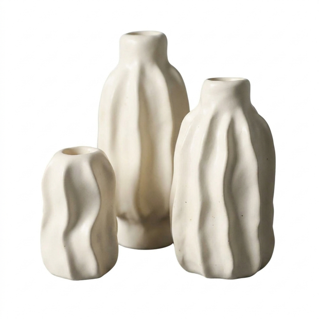 Set of rippled matte ceramic taper candle holders on a white background
