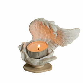 Resin angel wings candle holder on a white background