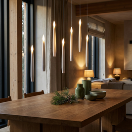 Set of flameless LED floating candles in a Japandi interior, floating at different heights above an oak dining table