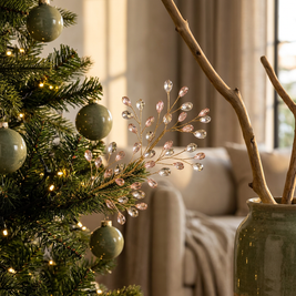 Beaded pearl and crystal look Christmas tree picks close-up, tucked into the branches of a Christmas tree