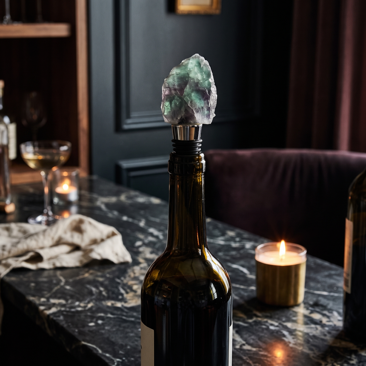 Raw crystal wine bottle stopper, Fluorite, Silver in a dark editorial interior