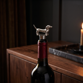 Dog wine bottle stopper, Dachshund, Silver in a dark editorial interior