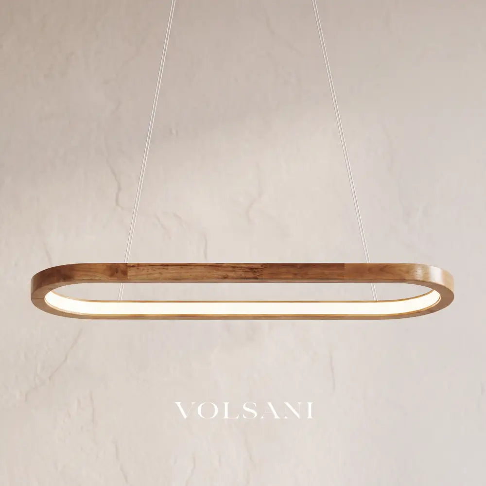 Close-up of the oval wooden pendant lamp hanging on its cord against a plaster wall