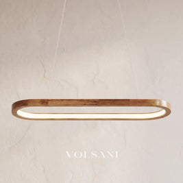 Close-up of the oval wooden pendant lamp hanging on its cord against a plaster wall