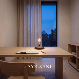 Levitating lamp with floating bulb lit on a desk in a Japandi home study at dusk
