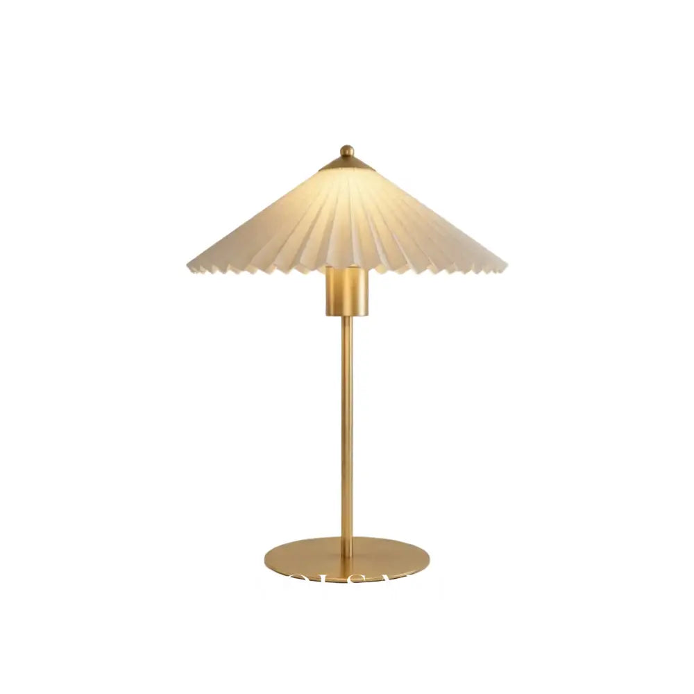 Mid century table lamp with pleated shade and brushed gold base, white background
