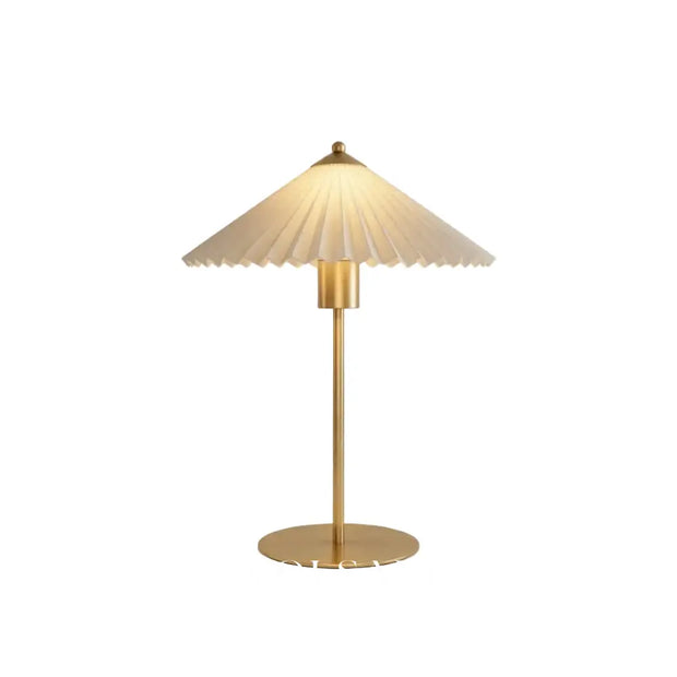 Mid century table lamp with pleated shade and brushed gold base, white background