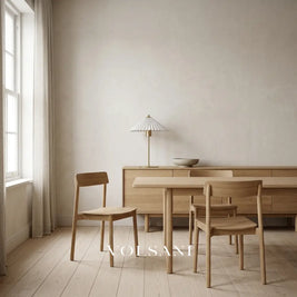 Brushed gold pleated-shade lamp switched off on an oak sideboard in a Japandi dining room