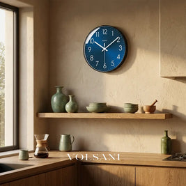 Modern wall clock with blue dial in a kitchen