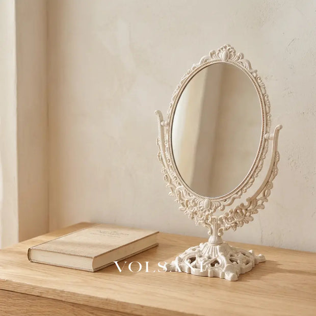 CORA carved frame vanity mirror on an oak surface