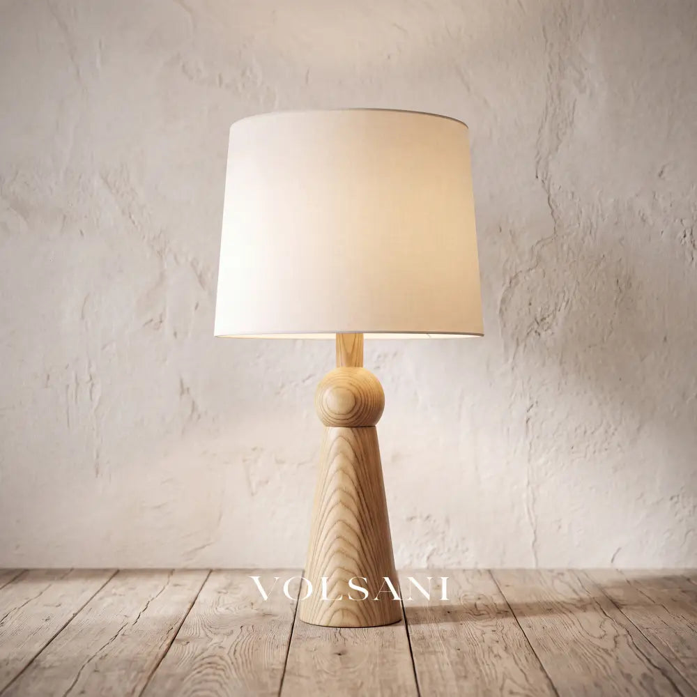 Close-up of the tall Scandinavian wood lamp against a plaster wall