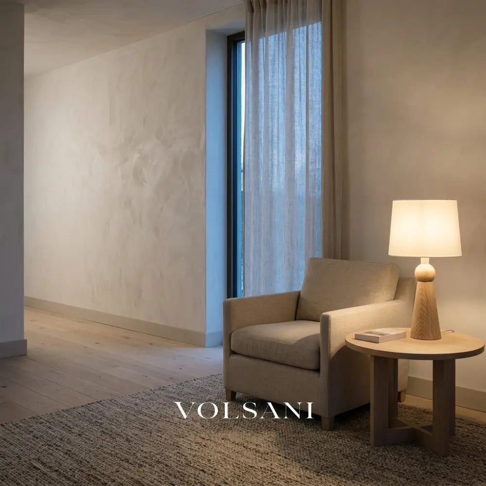 Scandinavian wood table lamp lit on a side table in a Japandi reading nook at dusk